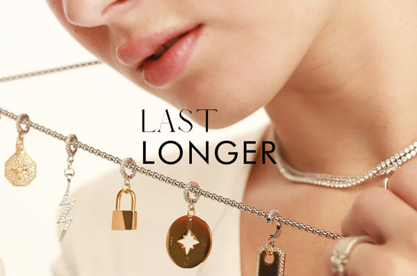 Woman Showing Artizan Necklace with different types of charms. Showing text that reads "Last Longer"