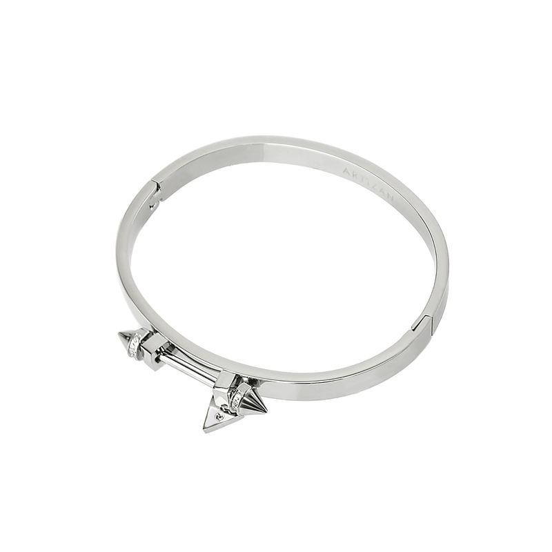 The Sasha's bangle made of 316L Stainless steel. It has a bar design on top with two spikes on each end. It has zirconia details and triangle charm as well.