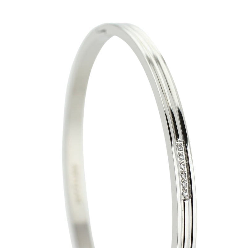 The THIN BANGLE which is made of rhodium plated Stainless steel with six tiny Cubic zirconia and dimensions of 2.8" x 1.77".