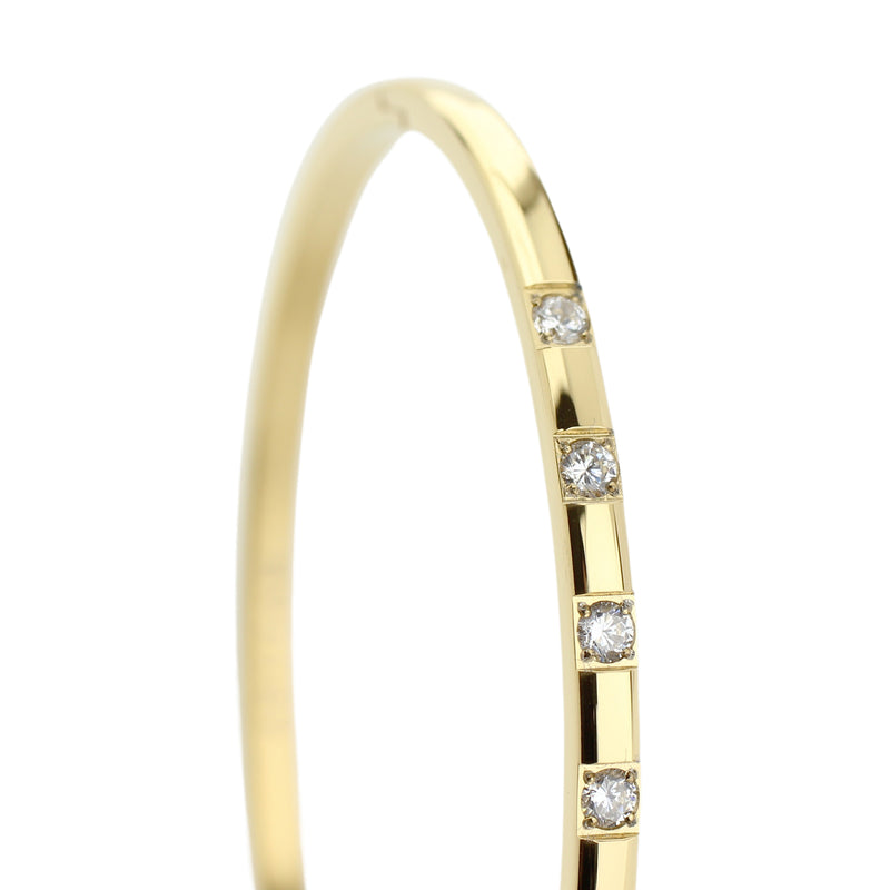 The SEQUENCE BANGLE which is made of Gold plated Stainless steel with seven Cubic zirconia and dimensions of 2.8" x 1.77".