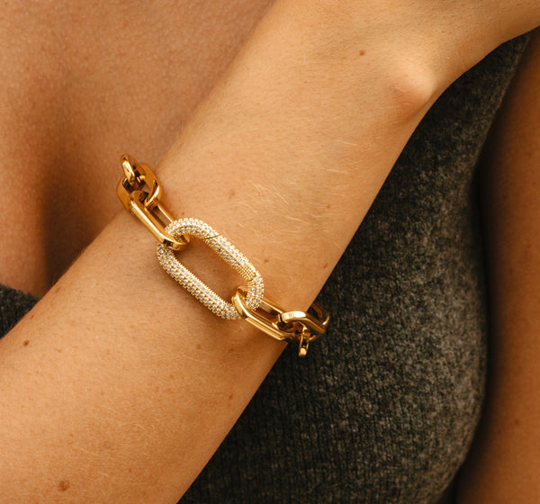 Model wearing the Puerto Fino Bracelet in gold plated stainless steel with a Micro Pave Zirconia lock.