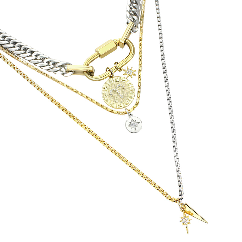 The Anne Zodiac Necklace which is a three pieces layered necklace set. Includes one silver chain with 18k gold plated carabiner and Gold Filled Aries Zodiac with Micro Pave Constellation charm, thin gold necklace with silver circle charm and another long necklace in half gold and silver with spike shaped charm and Gold Plated Micro Pave Studded Star.
