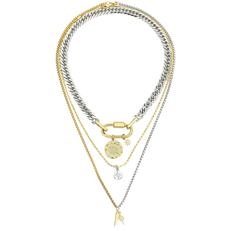 The Anne Zodiac Necklace which is a three pieces layered necklace set. Includes one silver chain with 18k gold plated carabiner and Gold Filled Scorpio Zodiac with Micro Pave Constellation charm, thin gold necklace with silver circle charm and another long necklace in half gold and silver with spike shaped charm and Gold Plated Micro Pave Studded Star. 