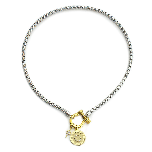 The Cancer Herradura Zodiac Necklace which is made of 18” Hypoallergenic Rhodium Plated Stainless Steel chain with 18K Gold Plated Horseshoe clasp and miniature star pendant and circular star sign micro pave Cancer constellation charm.