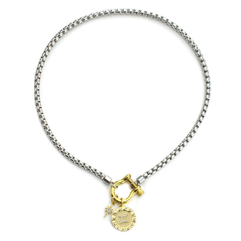 The Gemini Herradura Zodiac Necklace which is made of 18” Hypoallergenic Rhodium Plated Stainless Steel chain with 18K Gold Plated Horseshoe clasp and miniature star pendant and circular star sign micro pave Gemini constellation charm.