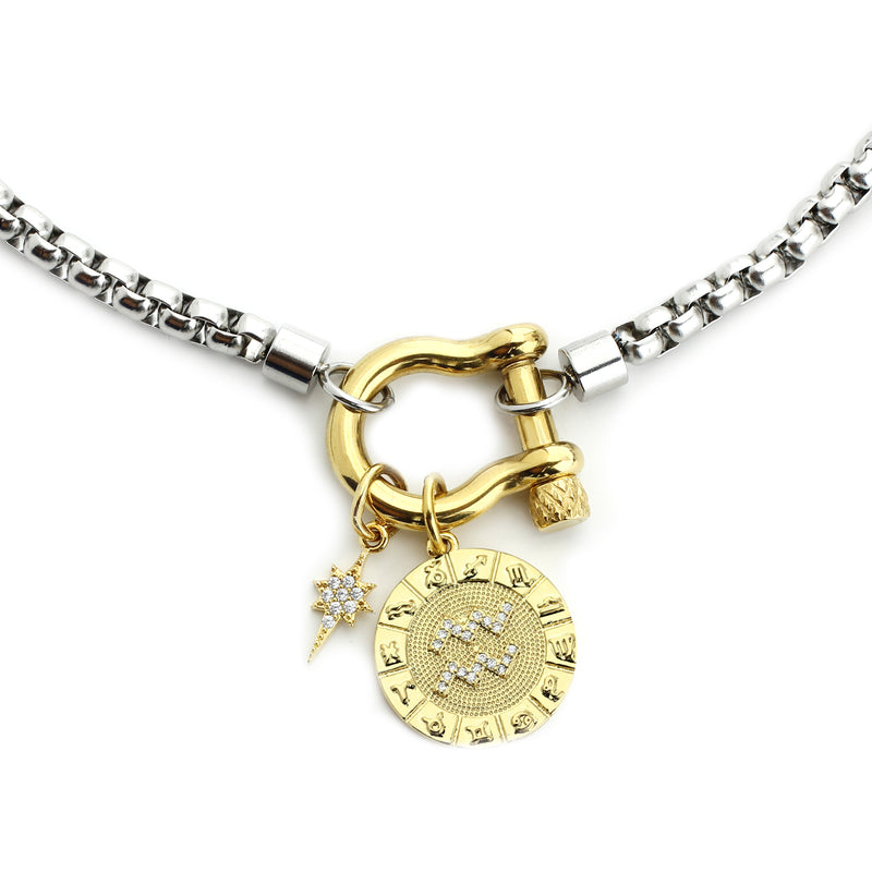 The Aquarius Herradura Zodiac Necklace which is made of 18” Hypoallergenic Rhodium Plated Stainless Steel chain with 18K Gold Plated Horseshoe clasp and miniature star pendant and circular star sign micro pave Aquarius constellation charm.
