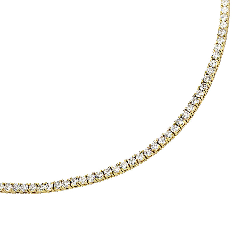 The GOLD TENIS NECKLACE which is made of 18k Gold plated brass/cubic zirconia that is 16" in length.