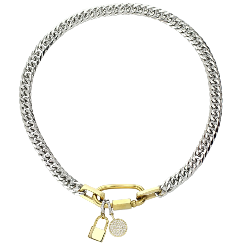 The Anne Mix necklace that has a silver chain and gold carabiner with The "Lock Clip on Charm" which is made of a Pave clip on Stainless steel 18k gold plated lock charm around 32mm in length and the DOT CLIP ON CHARM. 