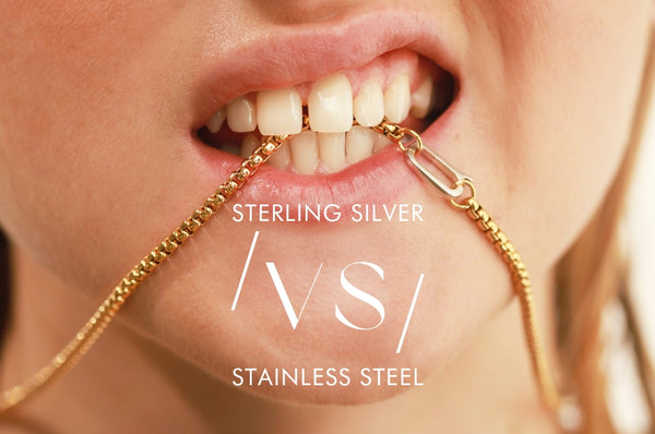 Woman biting an Artizan yellow gold necklace and showing text that reads "Sterling Silver VS Stainless Steel"