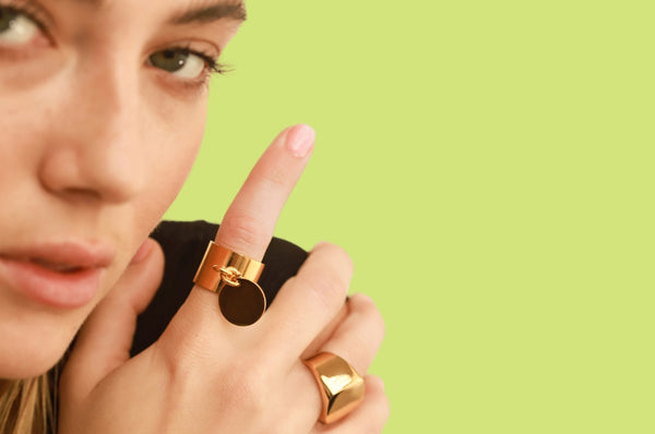 Close up woman showing Artizan Coin Ring in Yellow Gold