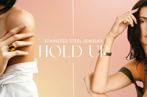 Two woman showing an Artizan Yellow gold ring and a silver bracelet and showing text that reads "Stainless steel Jewelry Hold Up"