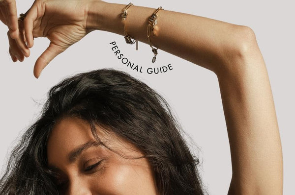 Woman with hand raised showing bracelets and the text personal guide