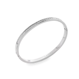 The DUST BANGLE, which is a single silver bracelet, features a refined and polished design highlighted by a sparkling row of stones along its sleek band. This elegant piece is perfect for wearing alone or stacking with other bracelets for a sophisticated, versatile style. ||| SILVER