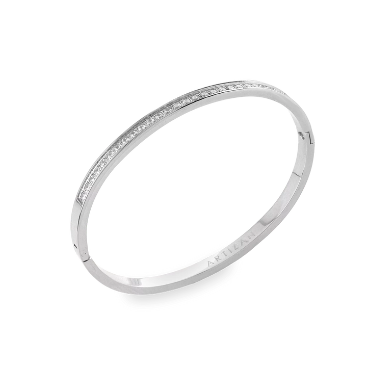 The DUST BANGLE, which is a single silver bracelet, features a refined and polished design highlighted by a sparkling row of stones along its sleek band. This elegant piece is perfect for wearing alone or stacking with other bracelets for a sophisticated, versatile style. ||| SILVER