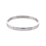 The Arrow Bangle, a silver bangle with diamond-like accents. ||| SILVER