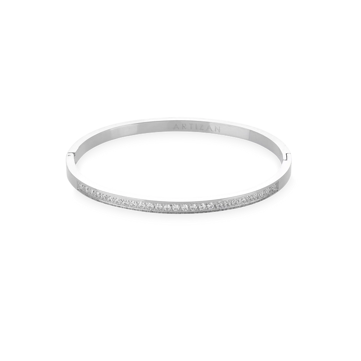 The DUST BANGLE, which is a single silver bracelet, features a refined and polished design highlighted by a sparkling row of stones along its sleek band. This elegant piece is perfect for wearing alone or stacking with other bracelets for a sophisticated, versatile style. ||| SILVER