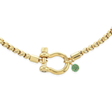 The Herradura Green Necklace, a single gold chain necklace featuring a bold clasp and a small green charm. This sleek and modern piece adds a touch of color and elegance, perfect for layering or wearing alone as a statement accessory.