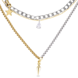 The SHINI SPIKE TRIO SET, which is a stunning layered necklace set featuring three intricately designed chains in mixed metals of gold and silver. This set includes bold chain links, delicate pendants including a star, teardrop, and spike charm, creating a modern and versatile accessory for any outfit.