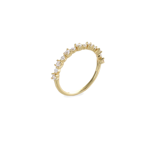 The Crown Ring, which is a single gold ring, features a delicate band adorned with a row of sparkling crystal accents in a crown-like design. This elegant piece is perfect for stacking or wearing alone for a subtle yet luxurious statement. Ideal for adding a touch of sophistication to everyday looks or special occasions.