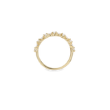 The Crown Ring, which is a single gold ring, features a delicate band adorned with a row of sparkling crystal accents in a crown-like design. This elegant piece is perfect for stacking or wearing alone for a subtle yet luxurious statement. Ideal for adding a touch of sophistication to everyday looks or special occasions.