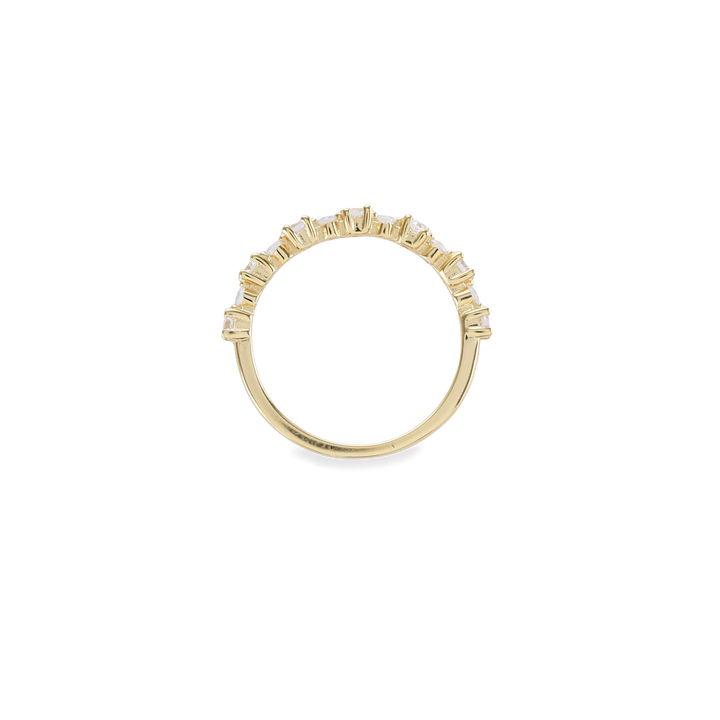 The Crown Ring, which is a single gold ring, features a delicate band adorned with a row of sparkling crystal accents in a crown-like design. This elegant piece is perfect for stacking or wearing alone for a subtle yet luxurious statement. Ideal for adding a touch of sophistication to everyday looks or special occasions.