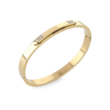 The Arrow Bangle, a gold bangle with diamond-like accents. ||| GOLD