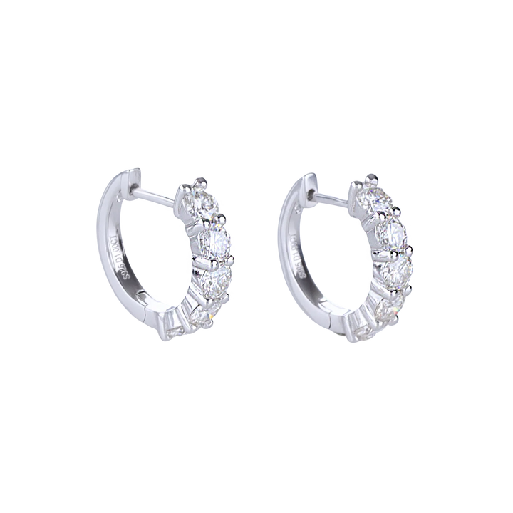The Main Hoop, which is a pair of silver-tone hoop earrings featuring a row of dazzling round-cut stones along the front, offering a statement design that combines elegance and brilliance for any occasion.