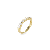 The Diamond Crown Half Band Ring which is a stunning single-piece ring crafted in gold, featuring a row of seven sparkling diamond-like stones set elegantly along the band. This piece combines timeless sophistication with modern luxury, perfect for adding a touch of brilliance to any outfit.