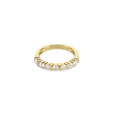 The Diamond Crown Half Band Ring which is a stunning single-piece ring crafted in gold, featuring a row of seven sparkling diamond-like stones set elegantly along the band. This piece combines timeless sophistication with modern luxury, perfect for adding a touch of brilliance to any outfit.