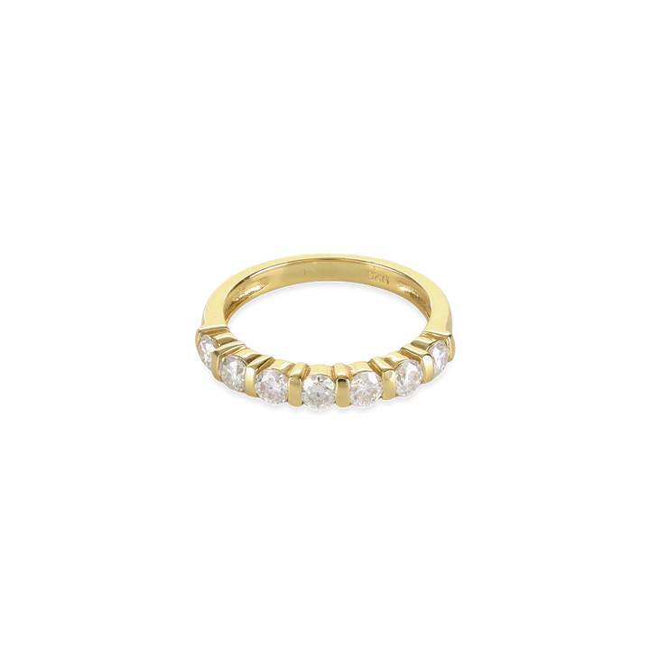 The Diamond Crown Half Band Ring which is a stunning single-piece ring crafted in gold, featuring a row of seven sparkling diamond-like stones set elegantly along the band. This piece combines timeless sophistication with modern luxury, perfect for adding a touch of brilliance to any outfit.