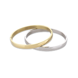The Doble Plain Set which is a two-piece bracelet stack featuring one gold-toned and one silver-toned bangle with a sleek and minimalist design, perfect for mixing metals and elevating your everyday look.