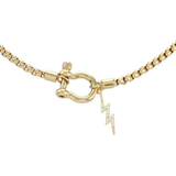 The Herradura Thunder Necklace - Gold, a single gold chain necklace featuring a bold clasp with a lightning bolt charm. This stylish and modern piece adds a touch of sparkle and edge, perfect for making a statement or layering with other gold accessories.