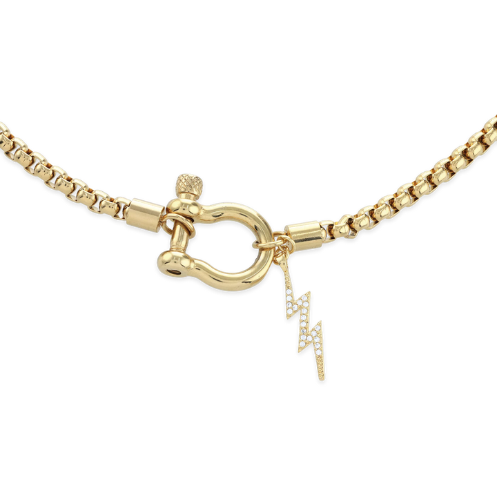 The Herradura Thunder Necklace - Gold, a single gold chain necklace featuring a bold clasp with a lightning bolt charm. This stylish and modern piece adds a touch of sparkle and edge, perfect for making a statement or layering with other gold accessories.