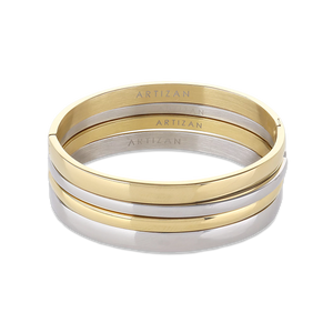 The Plain Medium Set, which is a multi-piece bracelet stack, features alternating gold and silver bangles with a sleek, polished finish, offering a chic and versatile design perfect for stacking together or wearing individually for a refined look.