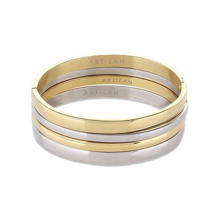 The Plain Medium Set, which is a multi-piece bracelet stack, features alternating gold and silver bangles with a sleek, polished finish, offering a chic and versatile design perfect for stacking together or wearing individually for a refined look.