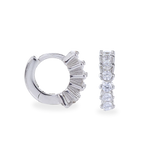 The Tiny Huggies Hoop, a pair of small silver hoop earrings that feature a row of sparkling cubic zirconia stones set in a  pointed, triangular pattern.||| SILVER
