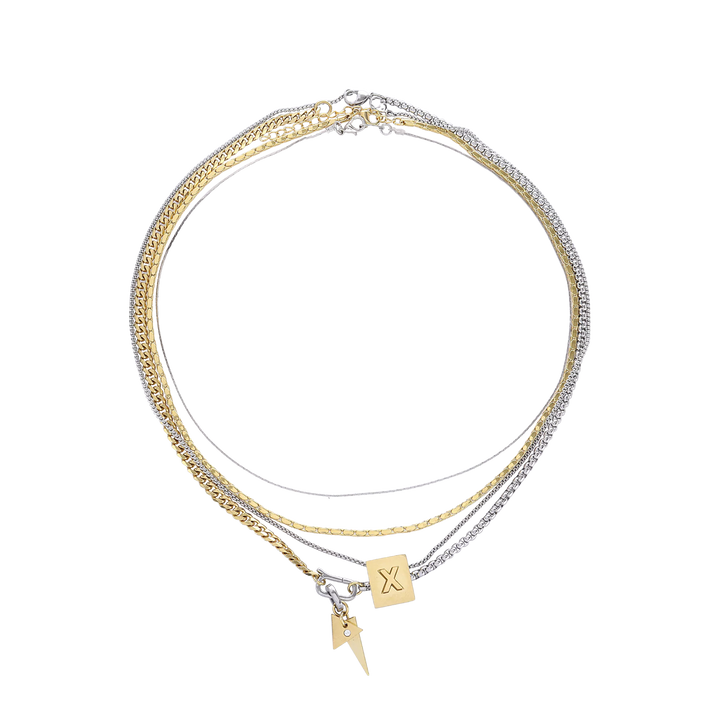The Letter Necklace Set, which is a three-piece layered necklace set, features a combination of gold and silver chains with two unique charms—a square charm engraved with a letter 'X' and a small lightning bolt pendant.