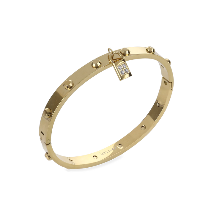 The Lock Bangle, which is a single gold bangle, features a studded design and a sparkling lock charm detail. This elegant piece in gold adds a secure, stylish touch with its distinct lock motif and subtle shimmer, perfect for making a bold statement on its own. ||| GOLD