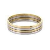 The Plain Thin Set, which is a four-piece bracelet stack, features alternating gold and silver bands with a sleek and polished finish, offering a minimalist yet sophisticated look for versatile styling.