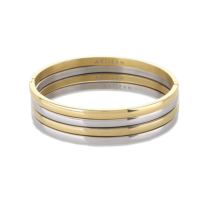 The Plain Thin Set, which is a four-piece bracelet stack, features alternating gold and silver bands with a sleek and polished finish, offering a minimalist yet sophisticated look for versatile styling.