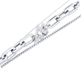 The SHINE PUERTO NECKLACE SET, which is a striking three-piece layered necklace in a polished silver finish. This set features bold chain links, a sparkling lightning bolt charm, and delicate accents, creating a perfect blend of edgy and elegant styles for versatile wear.