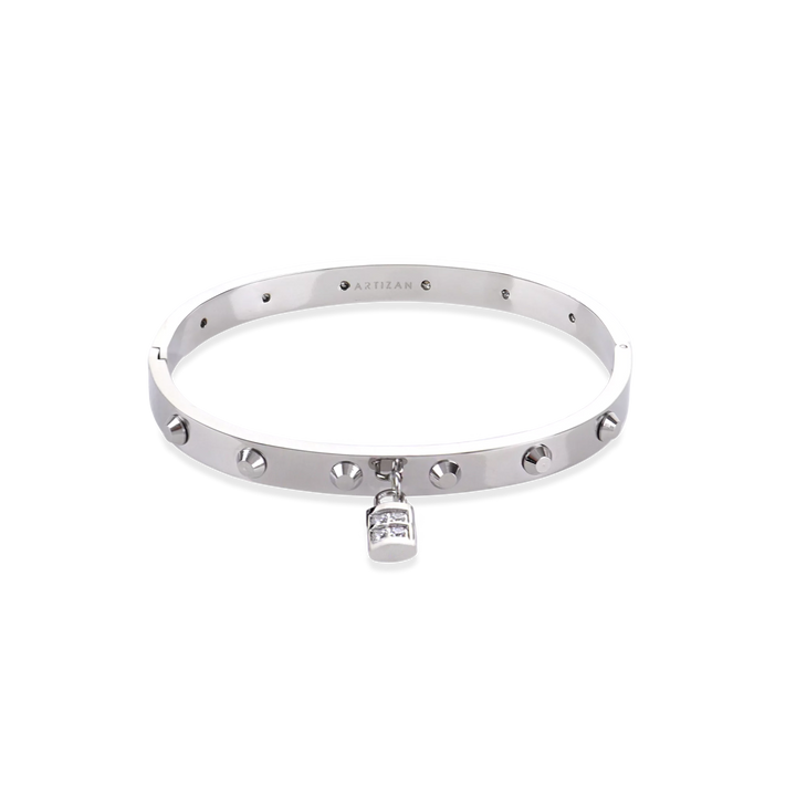 The Lock Bangle, which is a single silver bangle, features a studded design with a sparkling lock charm. This sleek piece in silver adds a refined, edgy touch with its distinctive lock detail, making it a versatile statement accessory on its own. ||| SILVER