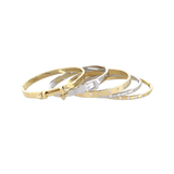 The Triangle Stack, which is a set of four sleek bangles, features a mix of gold and silver tones. The set includes a minimalist triangle clasp design and delicate embellishments of small gemstones, offering a chic and versatile accessory option