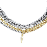 The Mulato Set, which is a four-piece layered necklace set, combines bold gold and silver chains with distinct textures and a drop pendant, offering a striking blend of modern elegance and statement-making versatility.