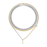 The Mulato Set, which is a four-piece layered necklace set, combines bold gold and silver chains with distinct textures and a drop pendant, offering a striking blend of modern elegance and statement-making versatility.