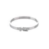The BELT BANGLE, a stylish silver bangle featuring a unique buckle clasp design with sparkling diamond accents. ||| SILVER