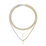 The Mix Set, which is a layered necklace set featuring four stunning pieces, combines gold and silver tones with intricate details. This versatile stack includes bold chain links, delicate pendants like a star charm and a pointed drop, creating a modern and chic mixed-metal look perfect for layering