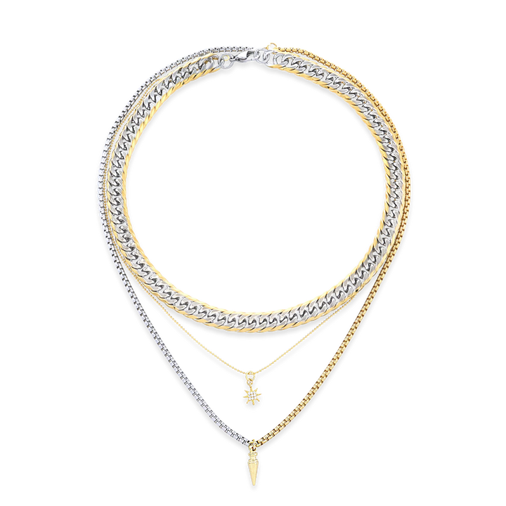 The Mix Set, which is a layered necklace set featuring four stunning pieces, combines gold and silver tones with intricate details. This versatile stack includes bold chain links, delicate pendants like a star charm and a pointed drop, creating a modern and chic mixed-metal look perfect for layering