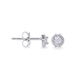 The Mini Stud Earring, which is a pair of delicate silver-tone earrings featuring a sparkling round-cut stone encased in a halo design, perfect for adding subtle elegance to any look.