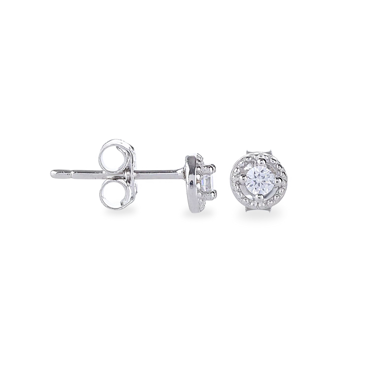 The Mini Stud Earring, which is a pair of delicate silver-tone earrings featuring a sparkling round-cut stone encased in a halo design, perfect for adding subtle elegance to any look.